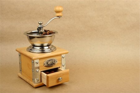 coffee mill full of beans on brown background Stock Photo - Budget Royalty-Free & Subscription, Code: 400-03993938