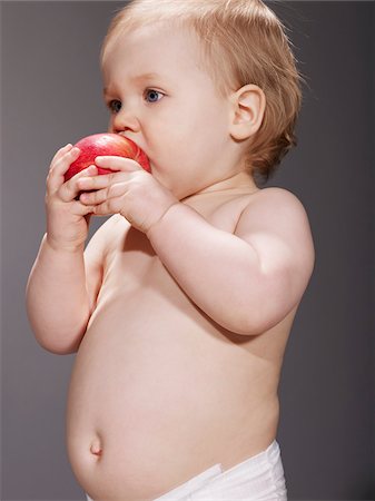 diaper girl - Baby Girl Eating an Apple Stock Photo - Premium Royalty-Free, Code: 600-04424896