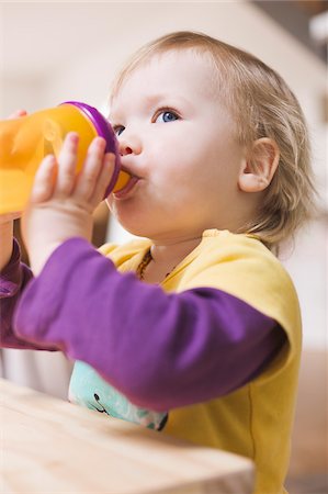 pictures of baby face side profile - Baby Girl Drinking from Spill Proof Cup Stock Photo - Premium Royalty-Free, Code: 600-04425159