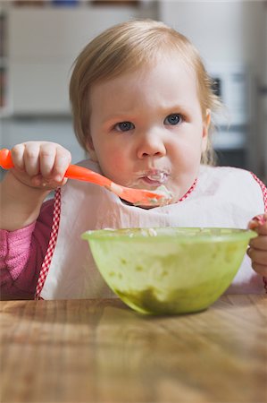 serious little girl - Baby Girl Eating from Bowl Stock Photo - Premium Royalty-Free, Code: 600-04425162