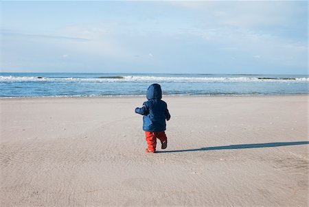 dutch (places and things) - Backview of Baby Girl Walking on Beach, Netherlands Stock Photo - Premium Royalty-Free, Code: 600-04926397