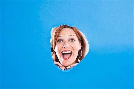 Woman Looking Through Hole Stock Photo - Premium Royalty-Free, Code: 600-05389116