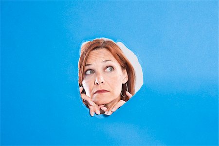 doubting woman - Woman Looking Through Hole Stock Photo - Premium Royalty-Free, Code: 600-05389117