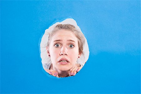 shocked teenagers - Teenage Girl Looking Through Hole Stock Photo - Premium Royalty-Free, Code: 600-05389113