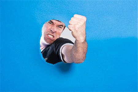 Man Looking Through Hole Stock Photo - Premium Royalty-Free, Code: 600-05389120