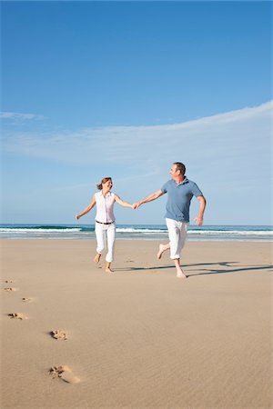 picture of 50 year old man running - Couple on Beach, Camaret-sur-Mer, Finistere, Bretagne, France Stock Photo - Premium Royalty-Free, Code: 600-05389157