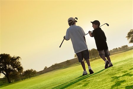 filtrado - Boys on Golf Course, PGA National Resort and Spa, Palm Beach Gardens, Florida, USA Foto de stock - Sin royalties Premium, Código: 600-05524087