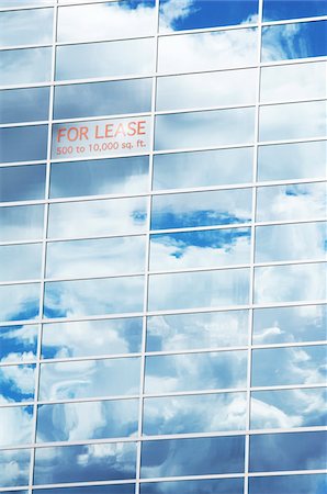 Sky and Clouds Reflected in Building Windows with For Lease Sign Stock Photo - Premium Royalty-Free, Code: 600-05524668