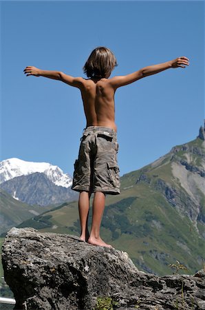 Back View of Boy Standing on Boulder, Alps, France Stock Photo - Premium Royalty-Free, Code: 600-05524683
