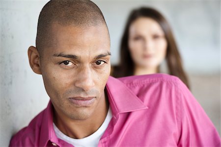 rejecting guy - Portrait of Man with Woman in Background Stock Photo - Premium Royalty-Free, Code: 600-05609746