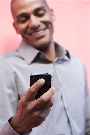 Man Looking at Cellphone Stock Photo - Premium Royalty-Free, Code: 600-05609755