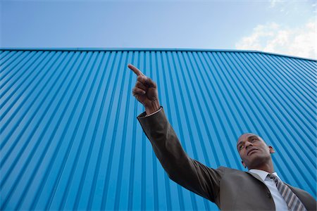 simsearch:600-05641523,k - Portrait of Businessman Pointing, Mannheim, Baden-Wurttemberg, Germany Stock Photo - Premium Royalty-Free, Code: 600-05641501