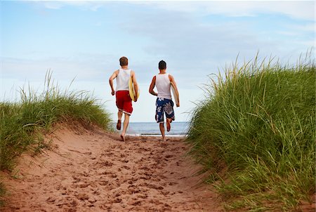 east coast - Young Men holding Skimboards while Running to Beach, PEI, Canada Stock Photo - Premium Royalty-Free, Code: 600-05641655