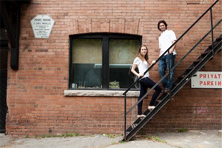 escalera de incendios - Portrait of Young Couple Standing on Fire Escape in Alleyway, Toronto, Ontario, Canada Foto de stock - Sin royalties Premium, Código: 600-05786156