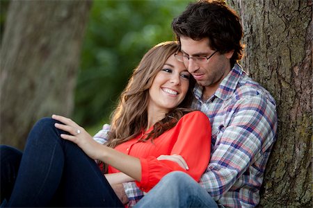 engagement ring - Close-up Portrait of Young Couple Sitting in Park Stock Photo - Premium Royalty-Free, Code: 600-05786181