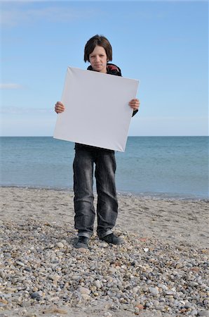 Boy Holding Blank Canvas on Beach, Sete, France Stock Photo - Premium Royalty-Free, Code: 600-05855266