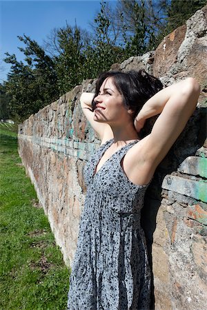 Woman Leaning against Wall Stock Photo - Premium Royalty-Free, Code: 600-05948137