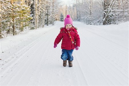 smile girl with footwear - Portrait of Little Girl Walking Down Road in Winter Stock Photo - Premium Royalty-Free, Code: 600-05973087