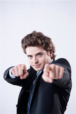 sólo hombres - Portrait of Young Businessman using Hand Gesture Foto de stock - Sin royalties Premium, Código: 600-05973099