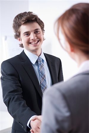 salesman - Young Businessman Shaking Hands with Businesswoman Stock Photo - Premium Royalty-Free, Code: 600-05973106