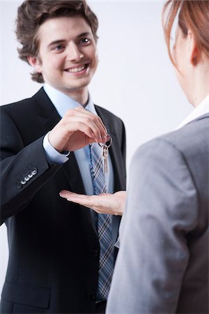 Young Businessman Giving Keys to Businesswoman Stock Photo - Premium Royalty-Free, Code: 600-05973108