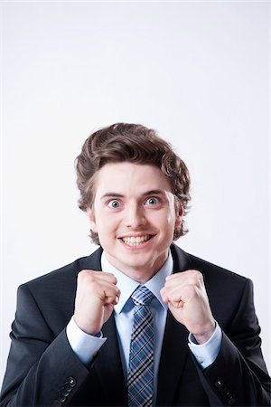 professional business man standing facing camera - Portrait of Excited Young Businessman Stock Photo - Premium Royalty-Free, Code: 600-05973114