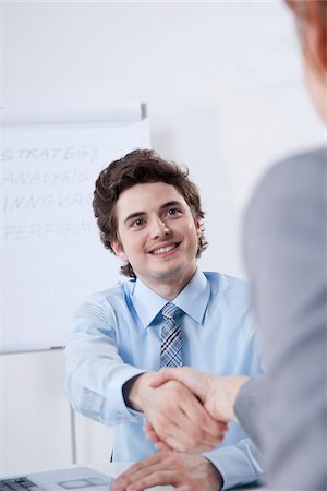 Young Businessman Shaking Hands with Businesswoman Stock Photo - Premium Royalty-Free, Code: 600-05973118