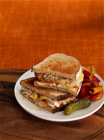 food selective focus - Turkey Reuben Sandwich with Pickle and Vegetable Chips Stock Photo - Premium Royalty-Free, Code: 600-06038277