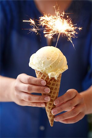Woman Holding Vanilla Ice Cream Cone with Sparkler Stock Photo - Premium Royalty-Free, Code: 600-06059753
