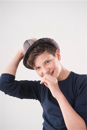 preteen boy happy white background - Portrait of Teenage Boy Stock Photo - Premium Royalty-Free, Code: 600-06144735