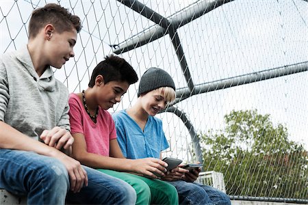summer clothes - Three Boys Playing Video Games in Playground, Mannheim, Baden-Wurttemberg, Germany Stock Photo - Premium Royalty-Free, Code: 600-06382849