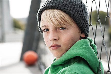 Portrait of punk pre-teen boy wearing sunglasses with arms crossed over  white background - Stock Photo - Masterfile - Premium Royalty-Free, Code:  693-06324842