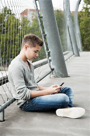 sitting fence - Boy, Mannheim, Baden-Wurttemberg, Germany Stock Photo - Premium Royalty-Free, Code: 600-06382918