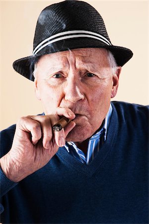 Portrait of Senior Man Smoking Cigar Stock Photo - Premium Royalty-Free, Code: 600-06382928