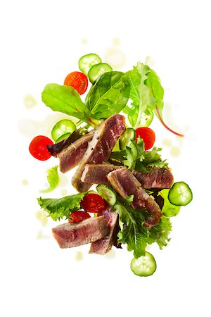 Tuna Steak Salad with Leafy Greens, Cucumber, and Cherry Tomatoes Stock Photo - Premium Royalty-Free, Code: 600-06383007