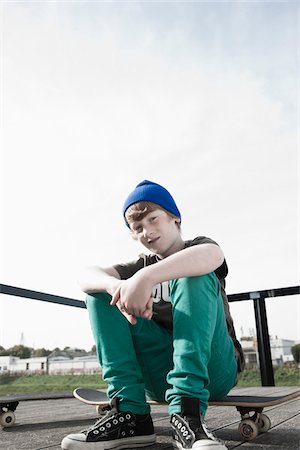 simsearch:600-06397450,k - Portrait of Boy Sitting on Skateboard, Mannheim, Baden-Wurttemberg, Germany Stock Photo - Premium Royalty-Free, Code: 600-06397454