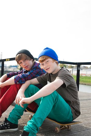 portrait of a young boy - Boys Sitting on Skateboards, Mannheim, Baden-Wurttemberg, Germany Stock Photo - Premium Royalty-Free, Code: 600-06397452