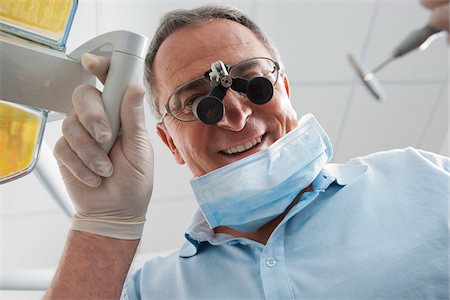 Close-up of Dentist with Magnifier on Eyeglasses in Dental Office, Germany Photographie de stock - Premium Libres de Droits, Code: 600-06438946