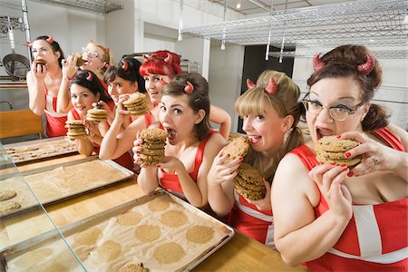 Women Wearing Devil Horns at a Bakery, Oakland, Alameda County, California, USA Stock Photo - Premium Royalty-Free, Code: 600-06431351