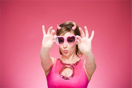 simsearch:600-06431419,k - Portrait of Woman Wearing Devil Horns and Heart Shaped Eyeglasses Foto de stock - Sin royalties Premium, Código: 600-06431416