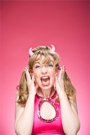simsearch:600-06431433,k - Portrait of Woman Wearing Devil Horns and Screaming Foto de stock - Sin royalties Premium, Código: 600-06431428