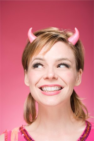 simsearch:600-06431373,k - Portrait of Woman Wearing Devil Horns Stock Photo - Premium Royalty-Free, Code: 600-06431422