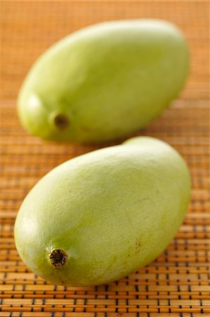 Close-up of Two Green Mangoes Stock Photo - Premium Royalty-Free, Code: 600-06451955