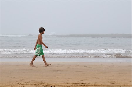 Boy Walking on Beach, Rabat, Morocco Stock Photo - Premium Royalty-Free, Code: 600-06451956