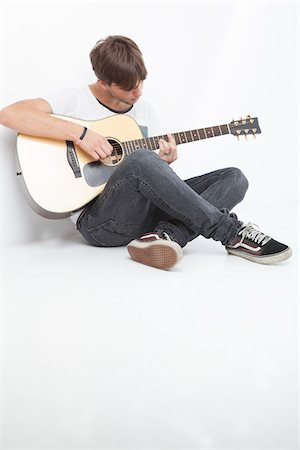 full body man white background not illustration and one person not happy - Young Man Playing Acoustic Guitar Stock Photo - Premium Royalty-Free, Code: 600-06465371