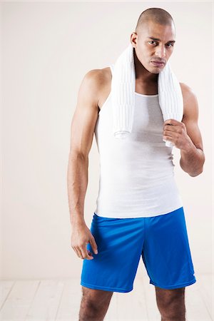 Man Wearing Work Out Clothes in Studio with White Background Stock Photo - Premium Royalty-Free, Code: 600-06485923