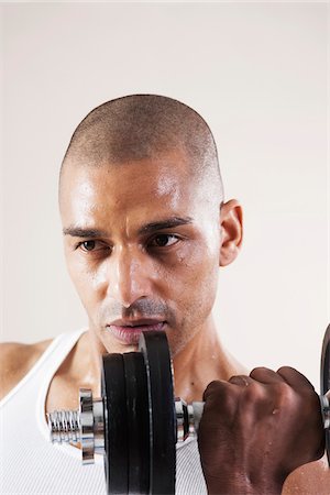 simsearch:600-06485944,k - Man Wearing Work Out Clothes and Lifting Weights in Studio with White Background Stock Photo - Premium Royalty-Free, Code: 600-06485935