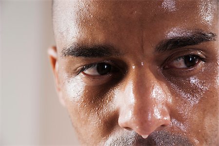 face close up serious - Close-Up Man's Sweating Face in Studio with White Background Stock Photo - Premium Royalty-Free, Code: 600-06485944