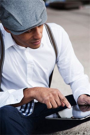 suspenders (straps worn over shoulders) - Portrait of Man Sitting on the Ground Using a Tablet, Mannheim, Baden-Wurttemberg, Germany Stock Photo - Premium Royalty-Free, Code: 600-06485967