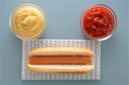 Overhead View of Hot Dog with Bowls of Ketchup and Mayonnaise, Studio Shot Fotografie stock - Premium Royalty-Free, Codice: 600-06486042